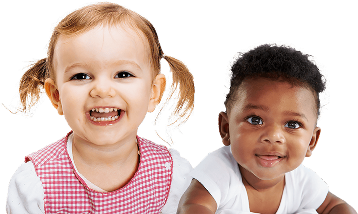 A girl with pigtails smiles brightly next to a baby boy, both exuding joy and innocence in a cheerful setting.